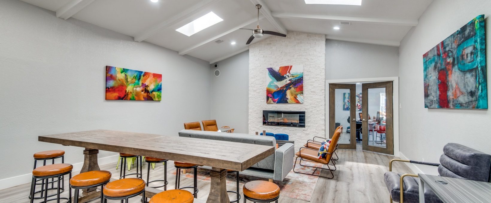 a living room with a pool table and bar stools at The  Booker