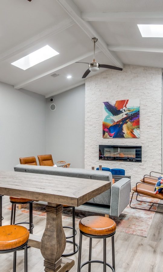 a living room with a pool table and bar stools at The  Booker